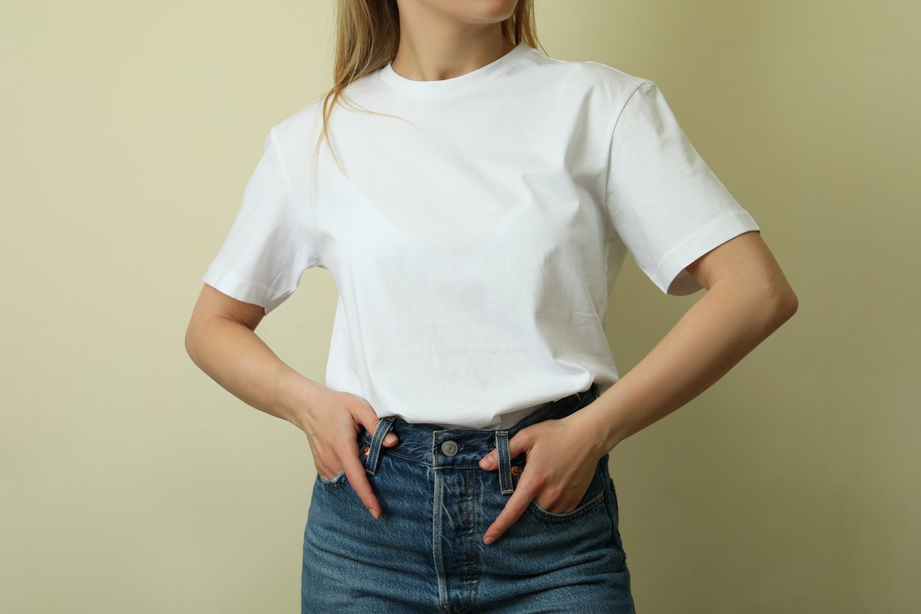 Young Woman in Blank T-Shirt against Beige Background